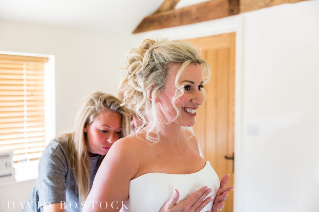 bride getting into dress