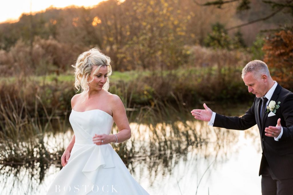 bride and groom by lake