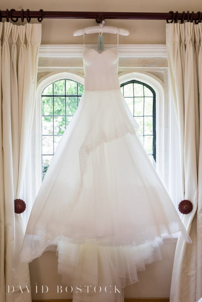 wedding dress hanging in window