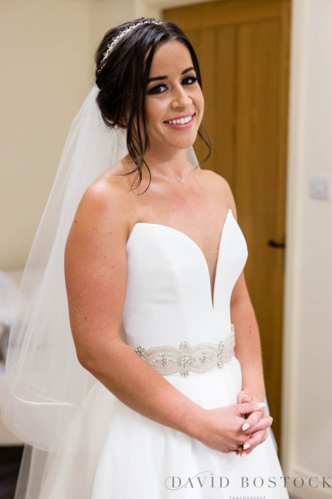 Bride wearing Suzanne Neville wedding dress at Caswell House