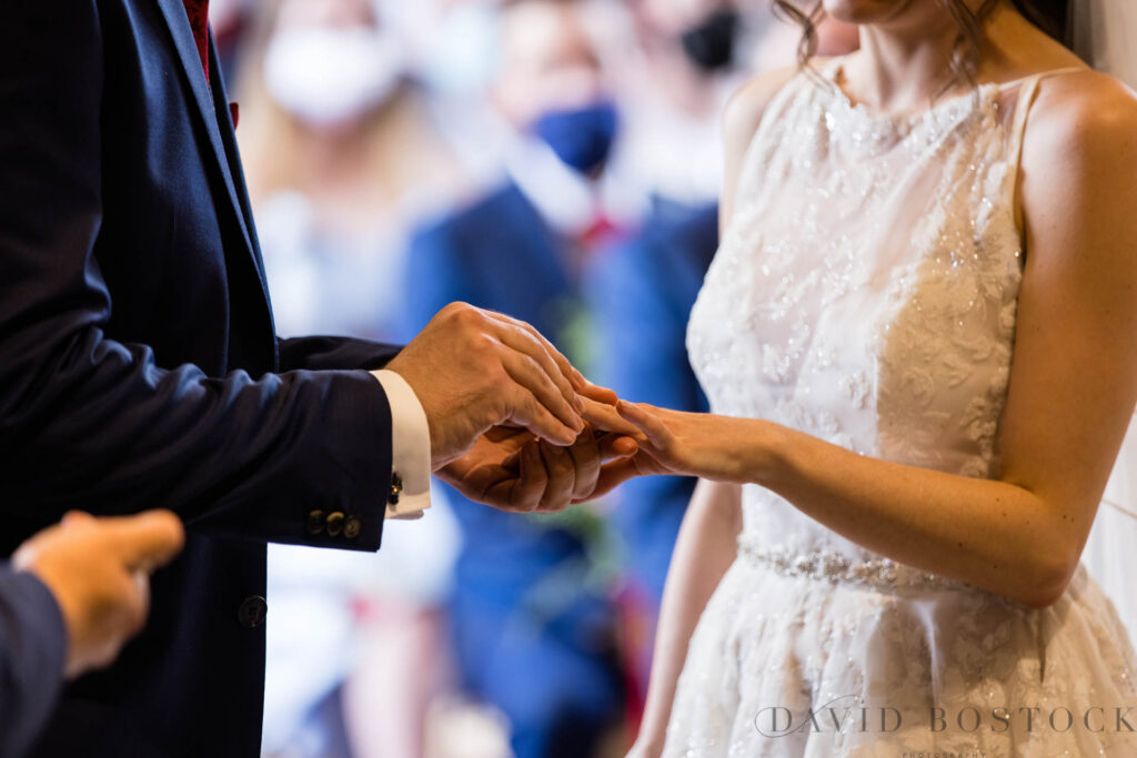 The Great Barn wedding exchanging rings