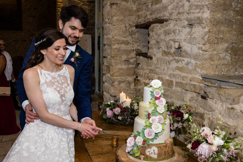 The Great Barn wedding cutting cake