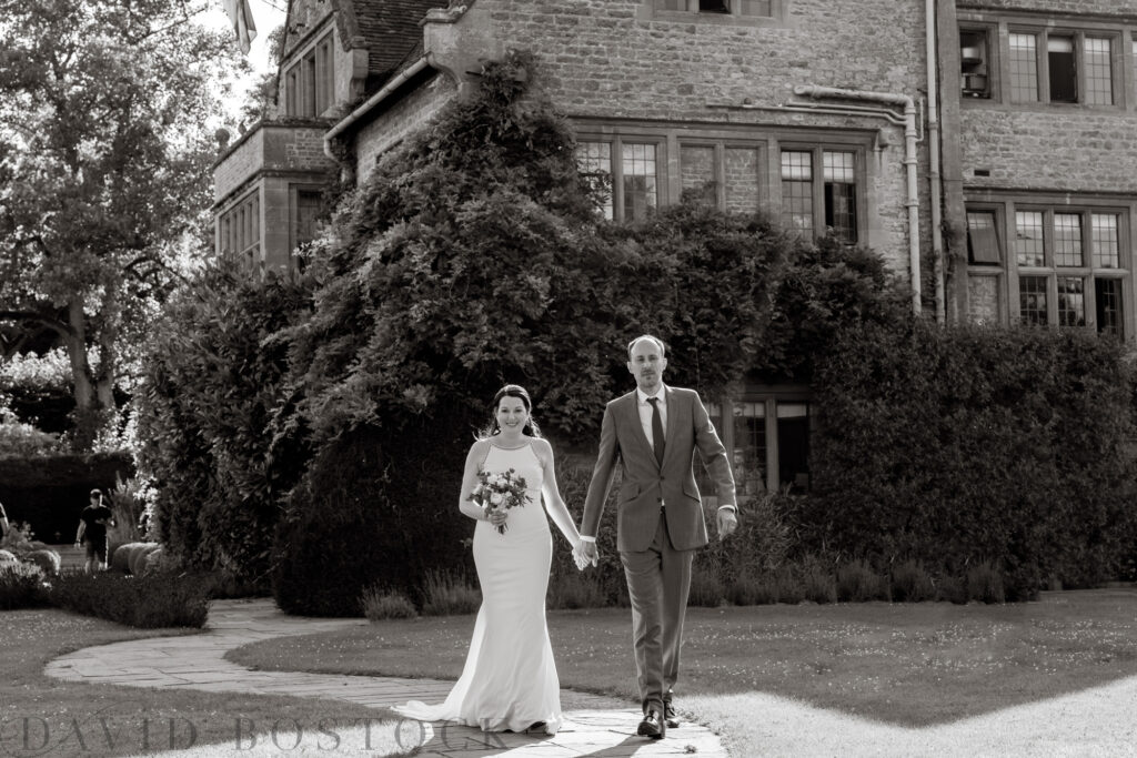 Bride and groom black and white photograph holding hands