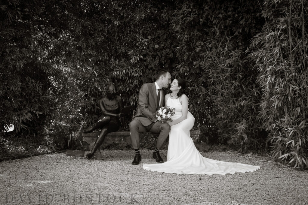 bride and groom smiling at each other while sitting down