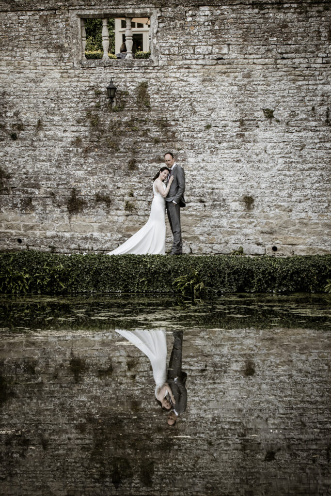 bride and groom by water's edge
