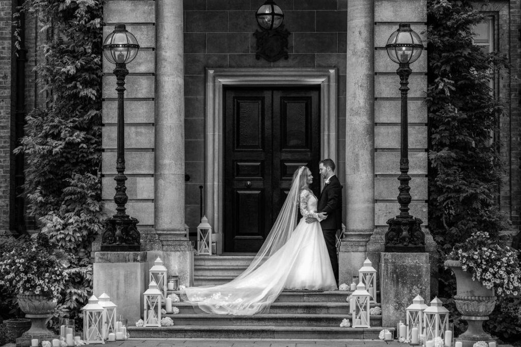wedding photography fellowship image -bride and groom standing in doorway at Hedsor House