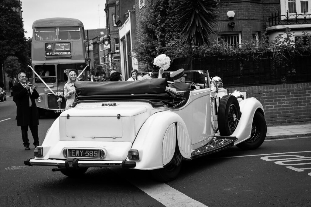 bride and groom driving off in rolls royce