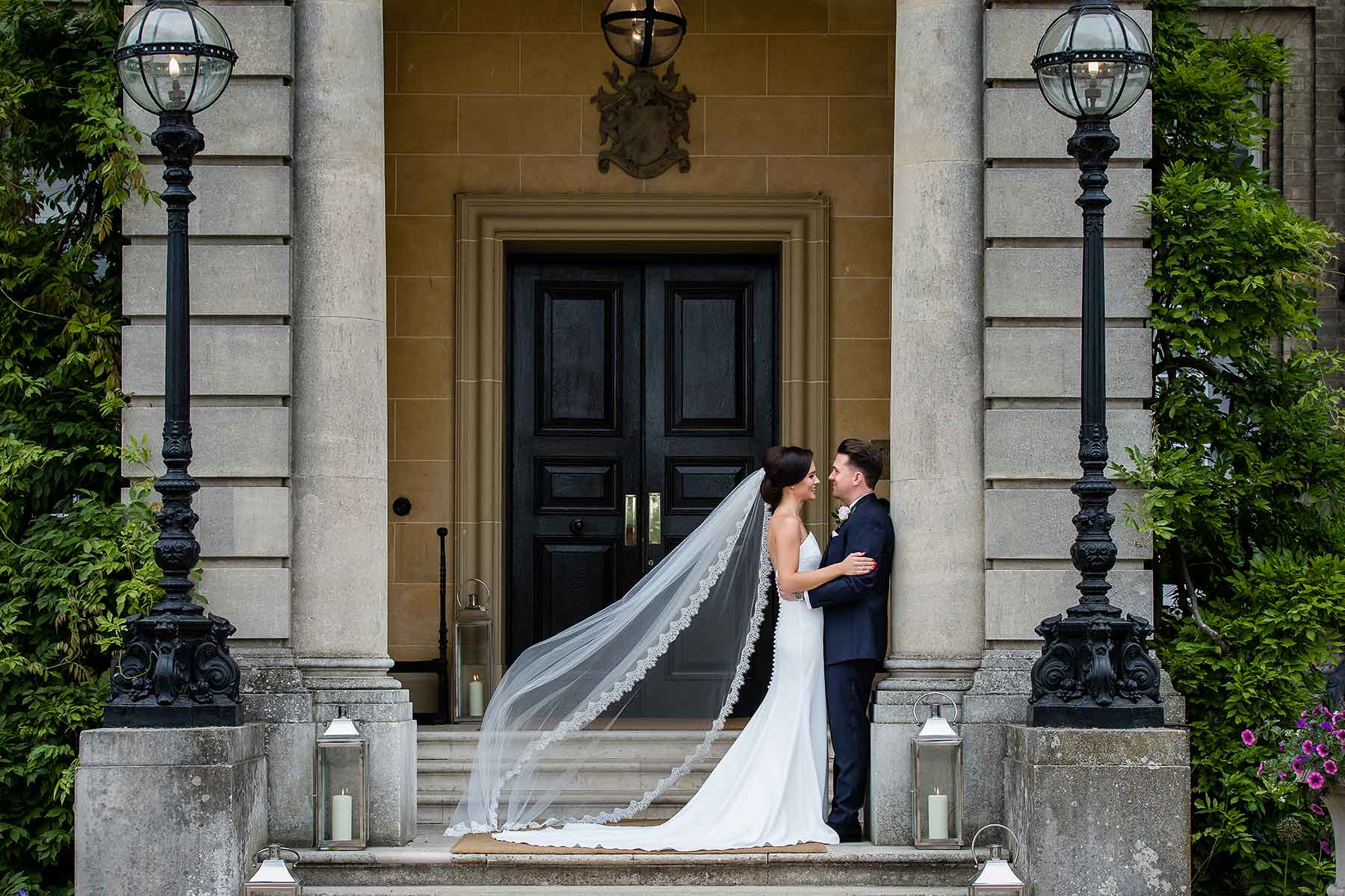 bride and groom on the steps outside Hedsor House