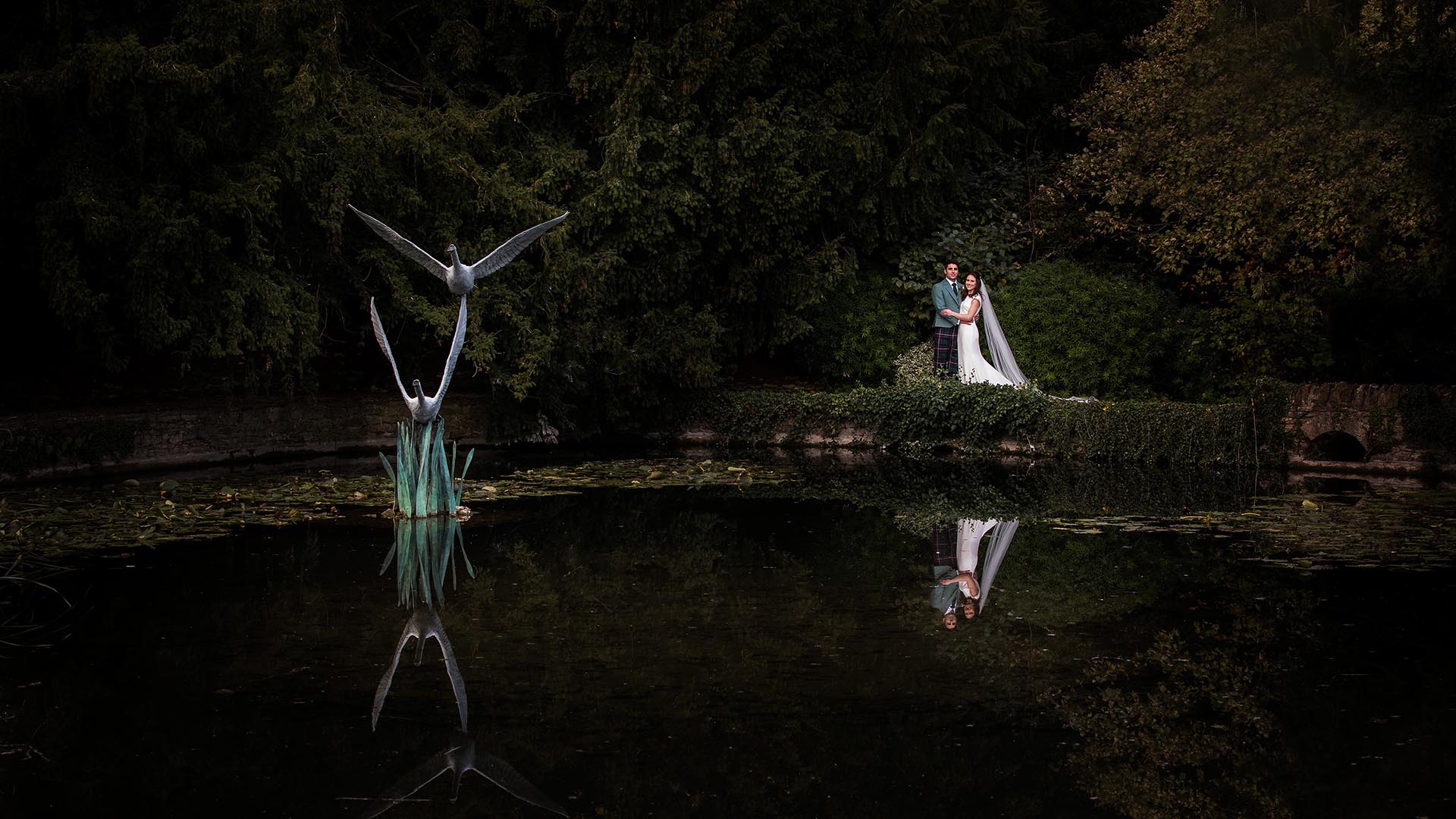 couple reflection in the pool at le manoir