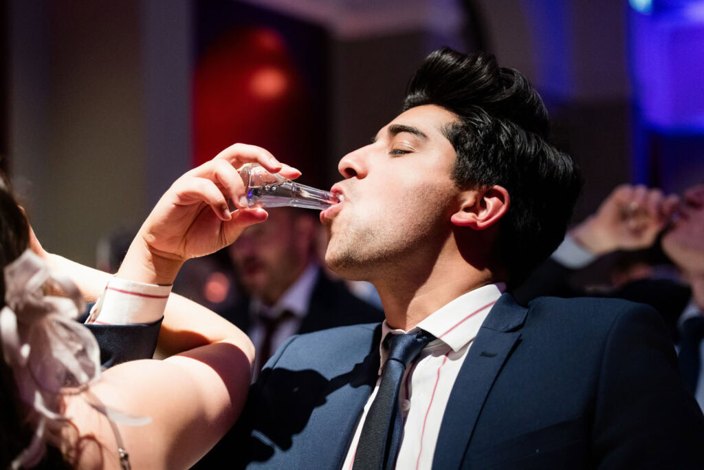 guests doing Romanian shots at Ashmolean wedding