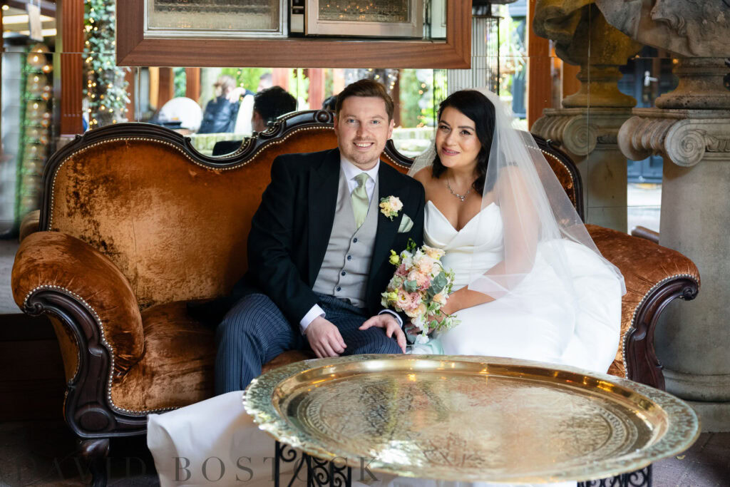 bride and groom sitting at a table at The Crazy Bear