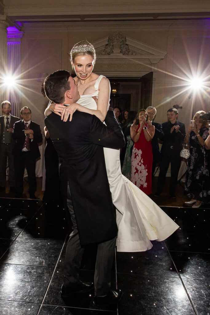 Groom lifting the bride during their first dance
