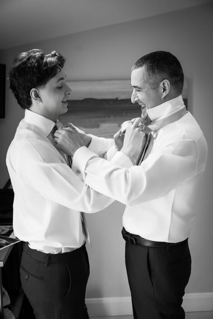 groom and son do up each other's ties