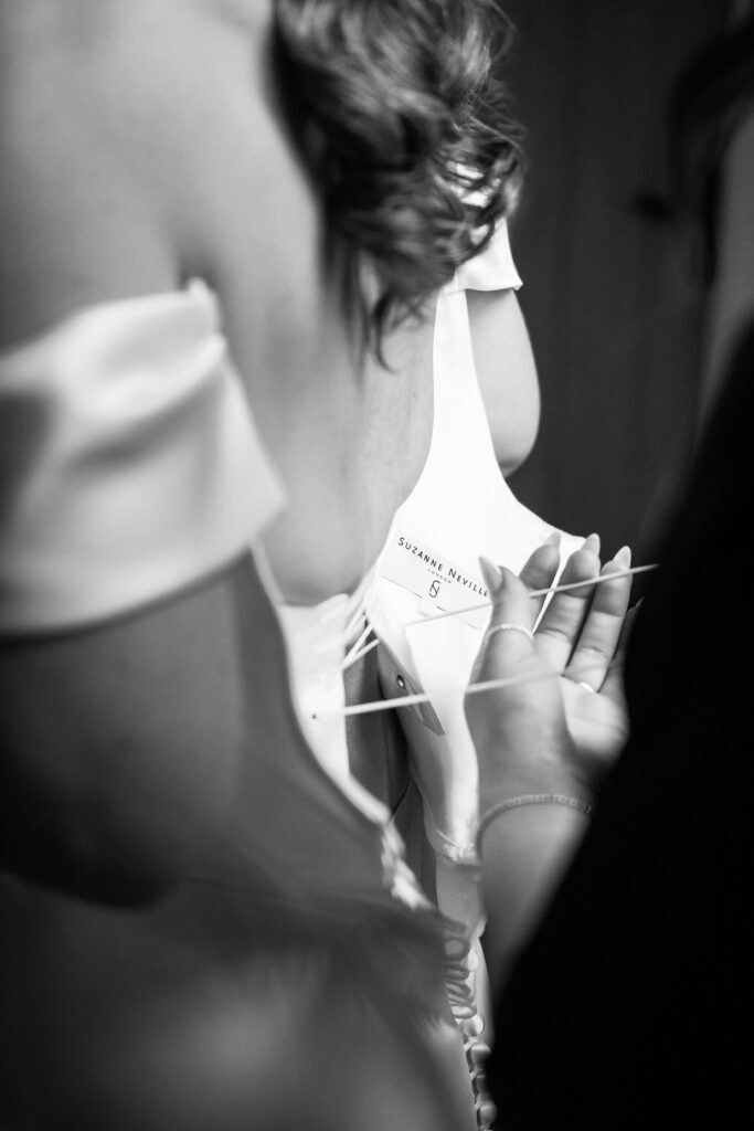 back of wedding dress being adjusted