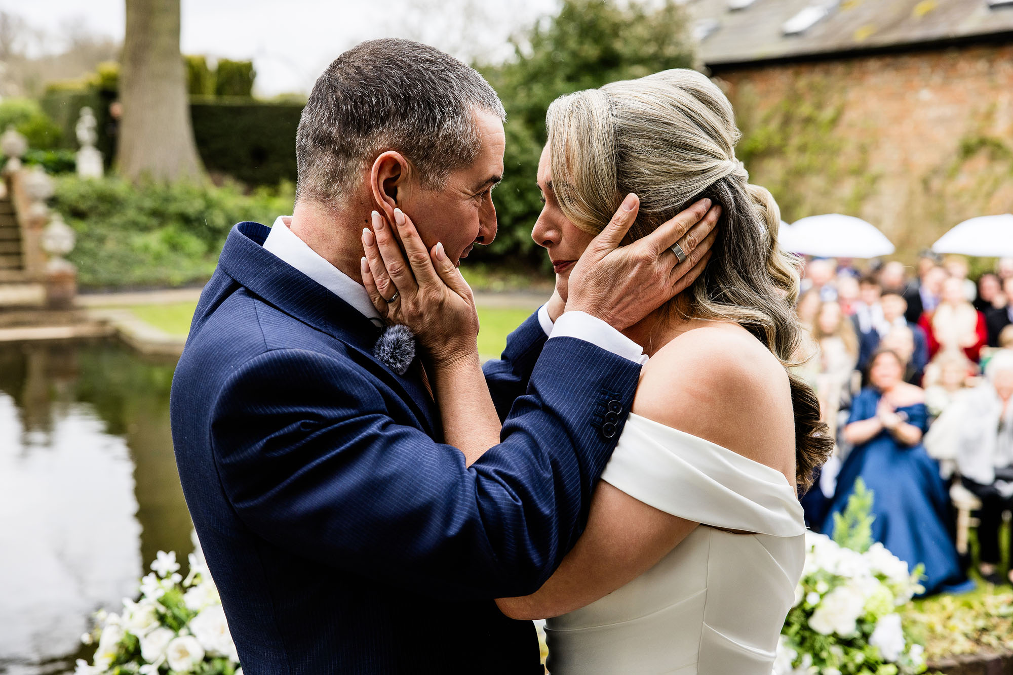 bride and groom holding each others faces tenderly