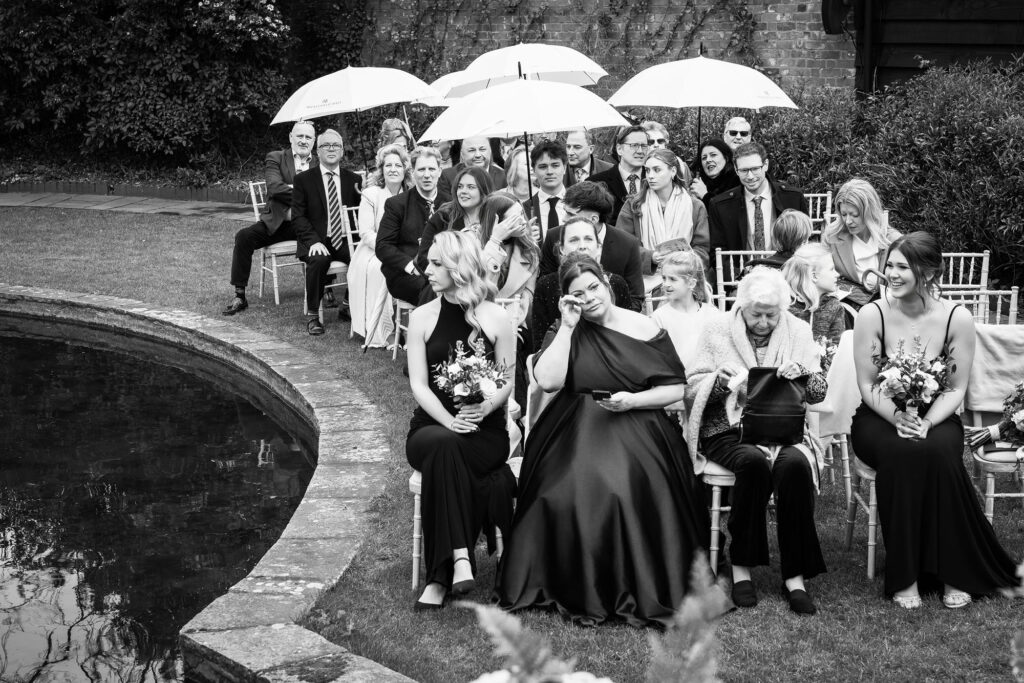 guests holding up umbrellas