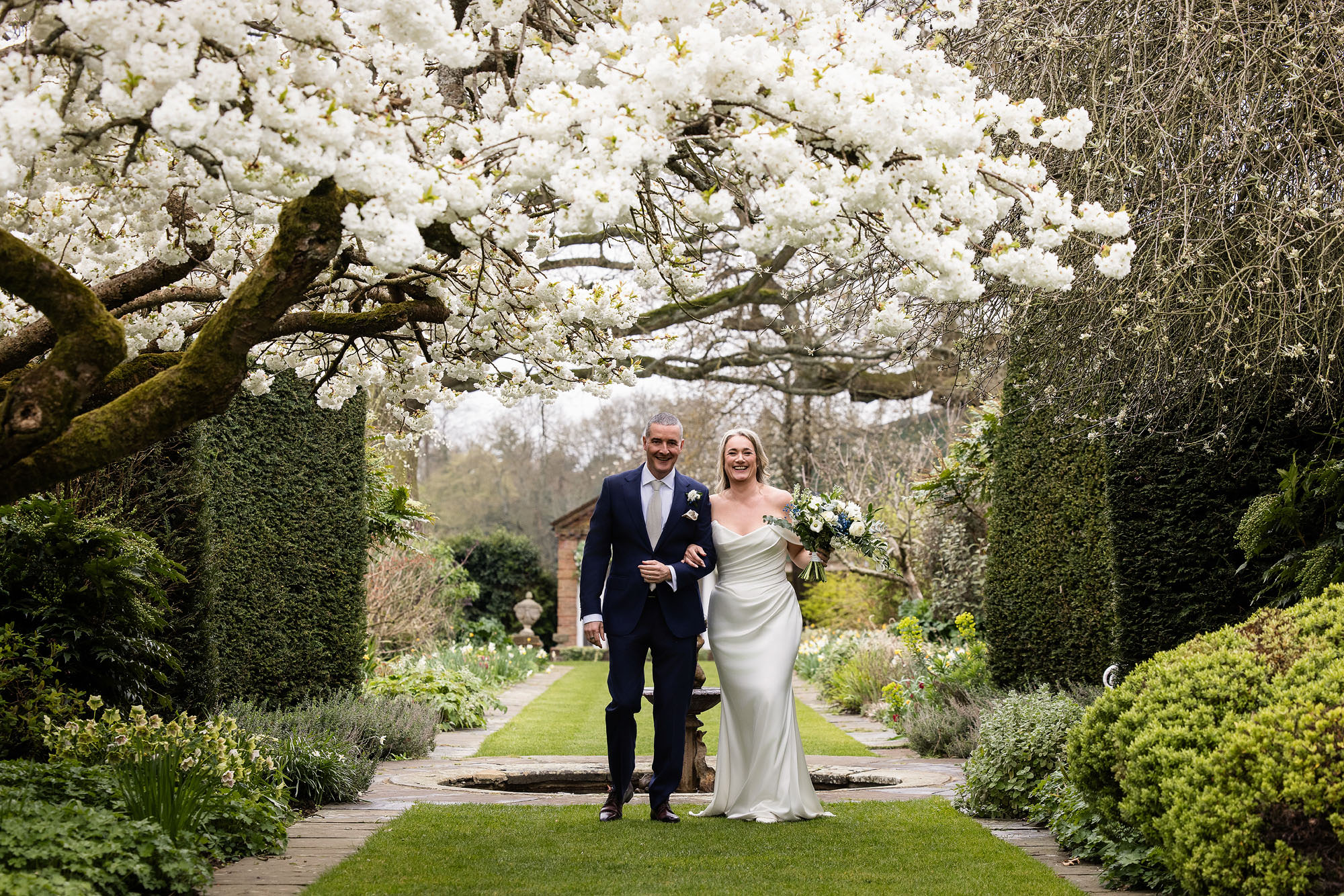 bride and groom surrounded by blossom