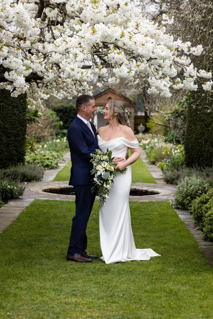 couple in blossom at spring Micklefield Hall wedding